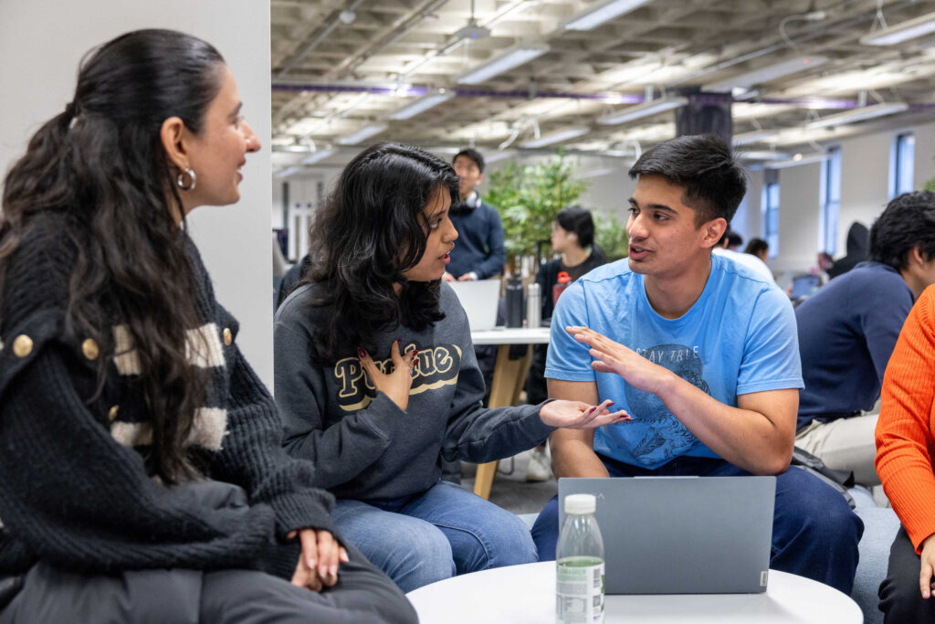 Three students in discussion.