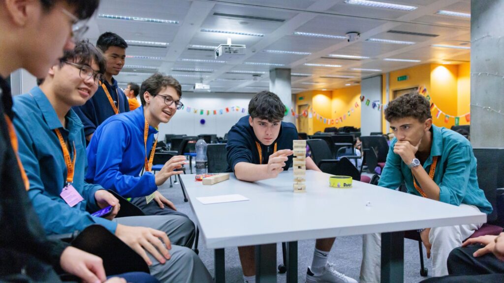 A group of global summer schools students playing Jenga.