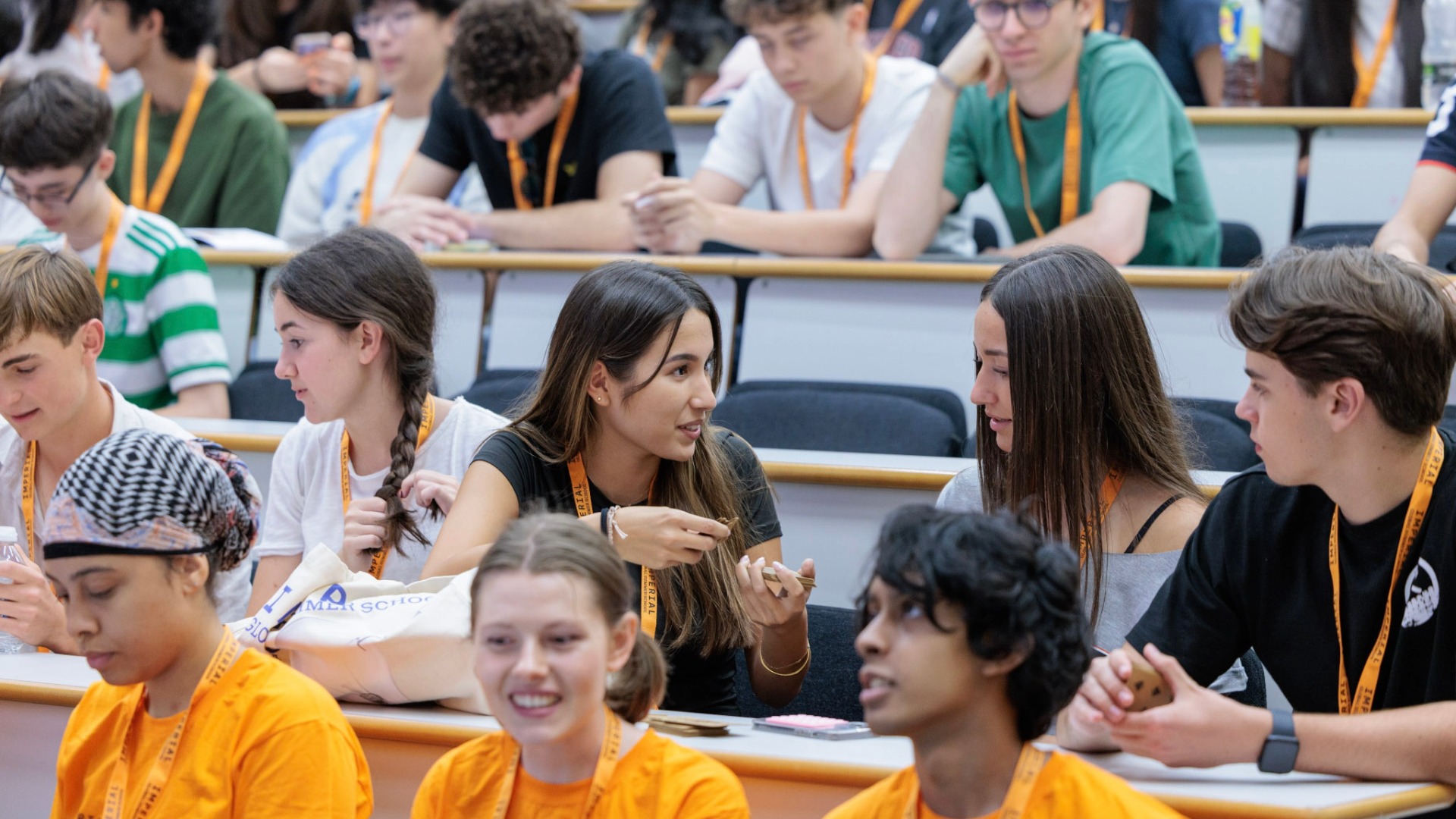 Two global Summer School students having a conversation in a lecture theatre