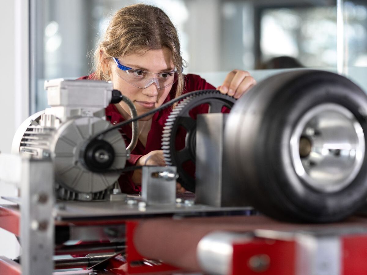Mechanical engineering student working on an engine